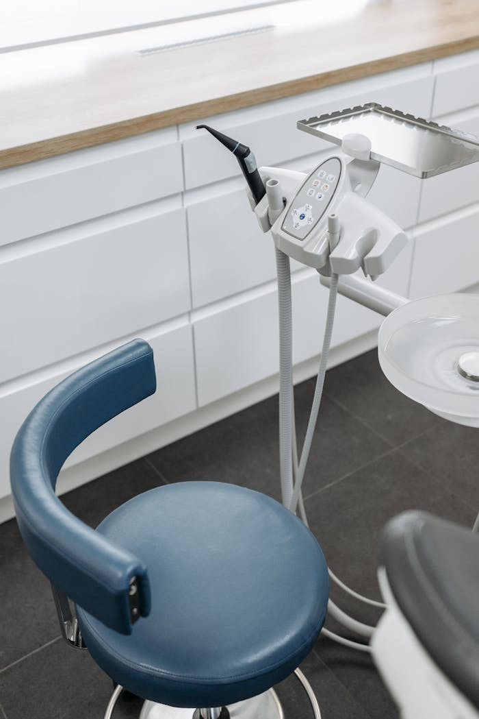 gallery-01 High-angle view of dental chair and equipment in a modern healthcare office.